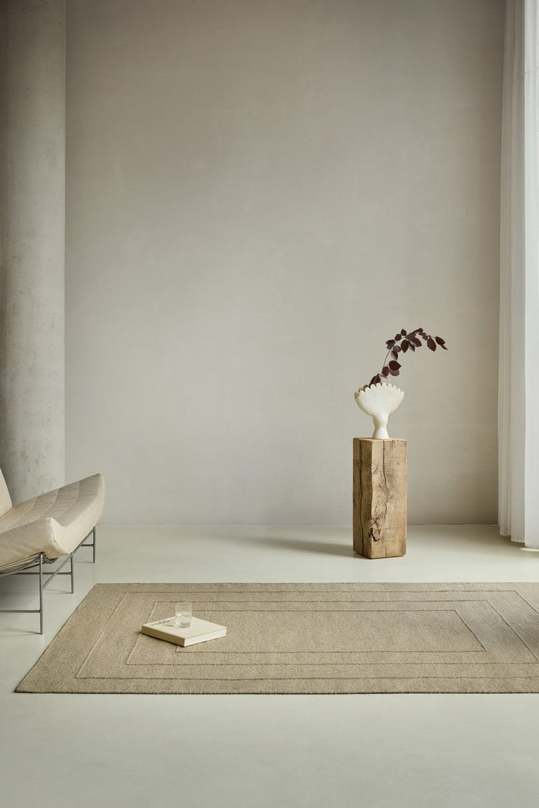 Brink & Campman Senso Border Natural rug in sand beige with three frames in relief, shown in an interior