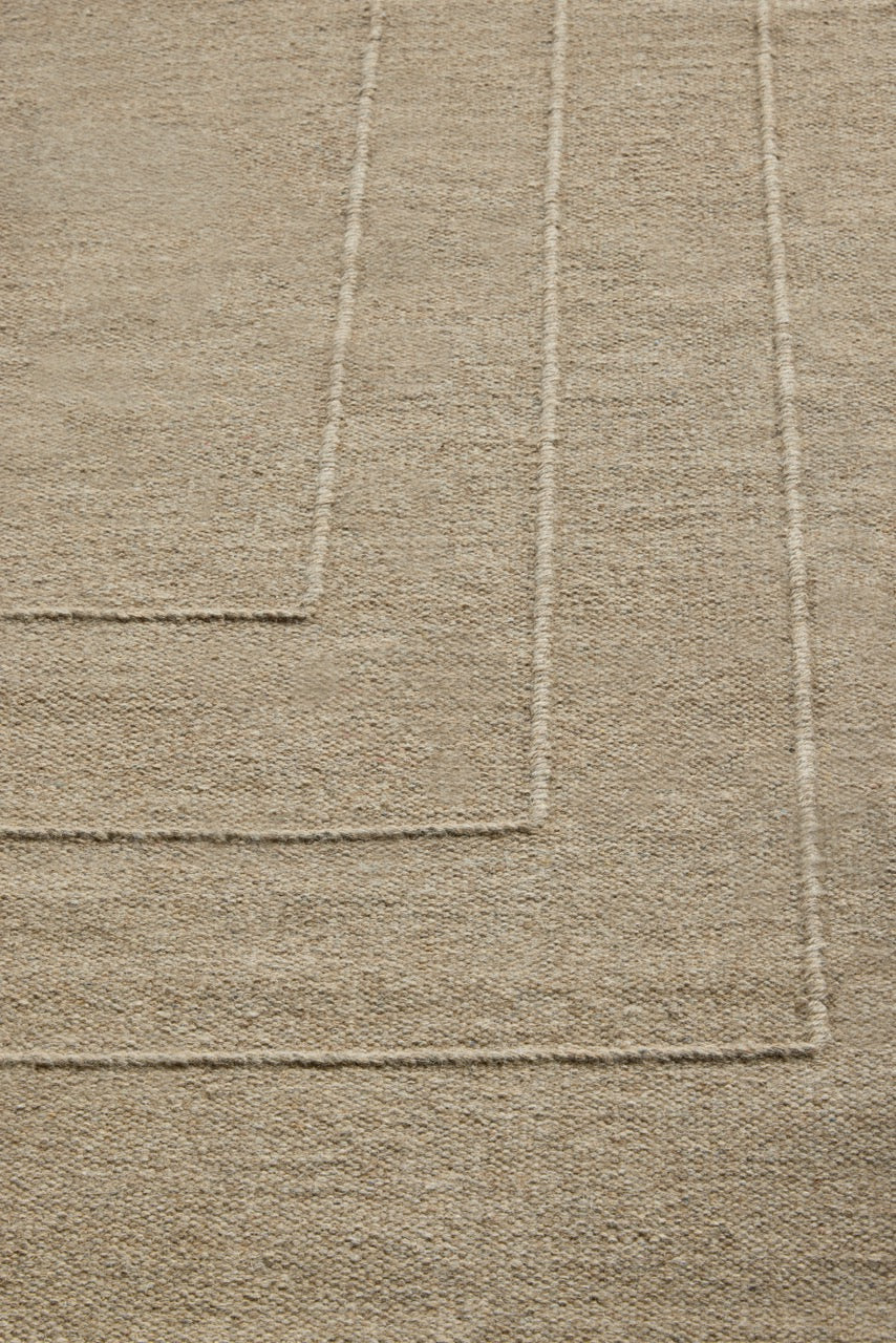 Brink & Campman Senso Border Natural rug in sand beige with three frames in relief, shown in an interior, second view