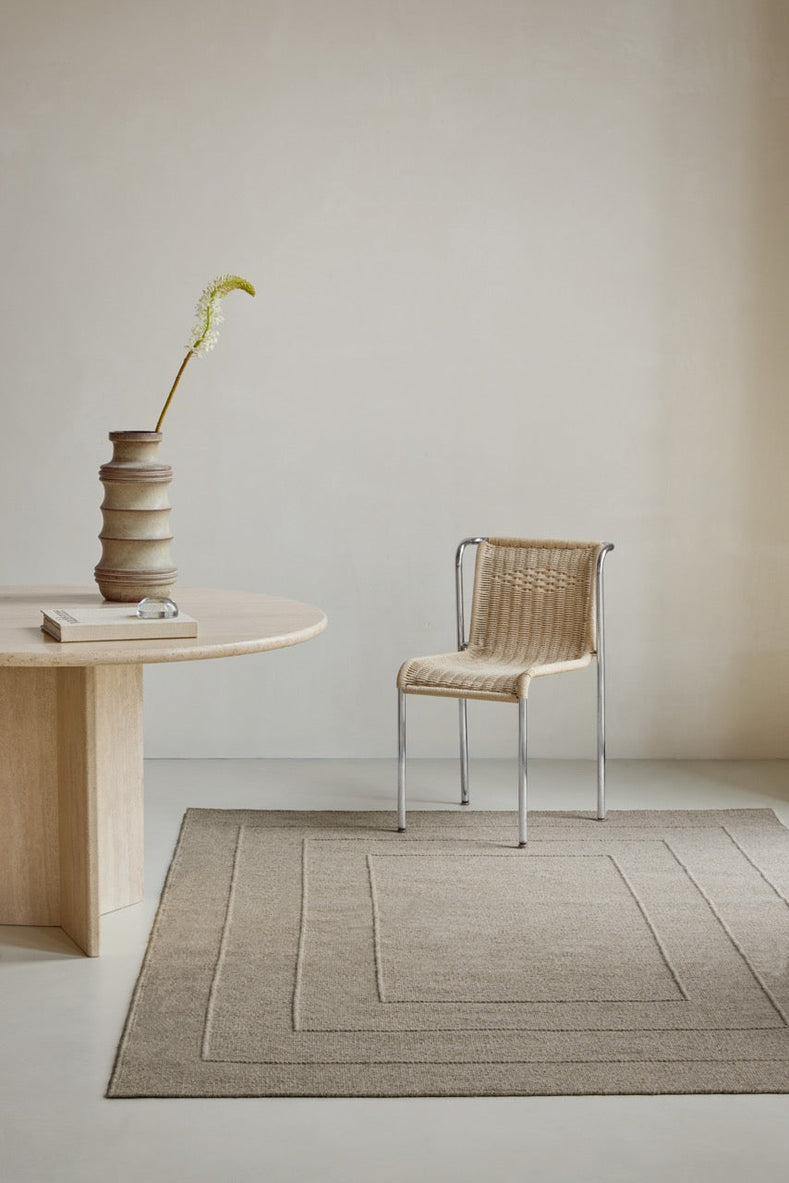 Brink & Campman Senso Border Soft Taupe rug in grey taupe with three frames in relief, shown in an interior