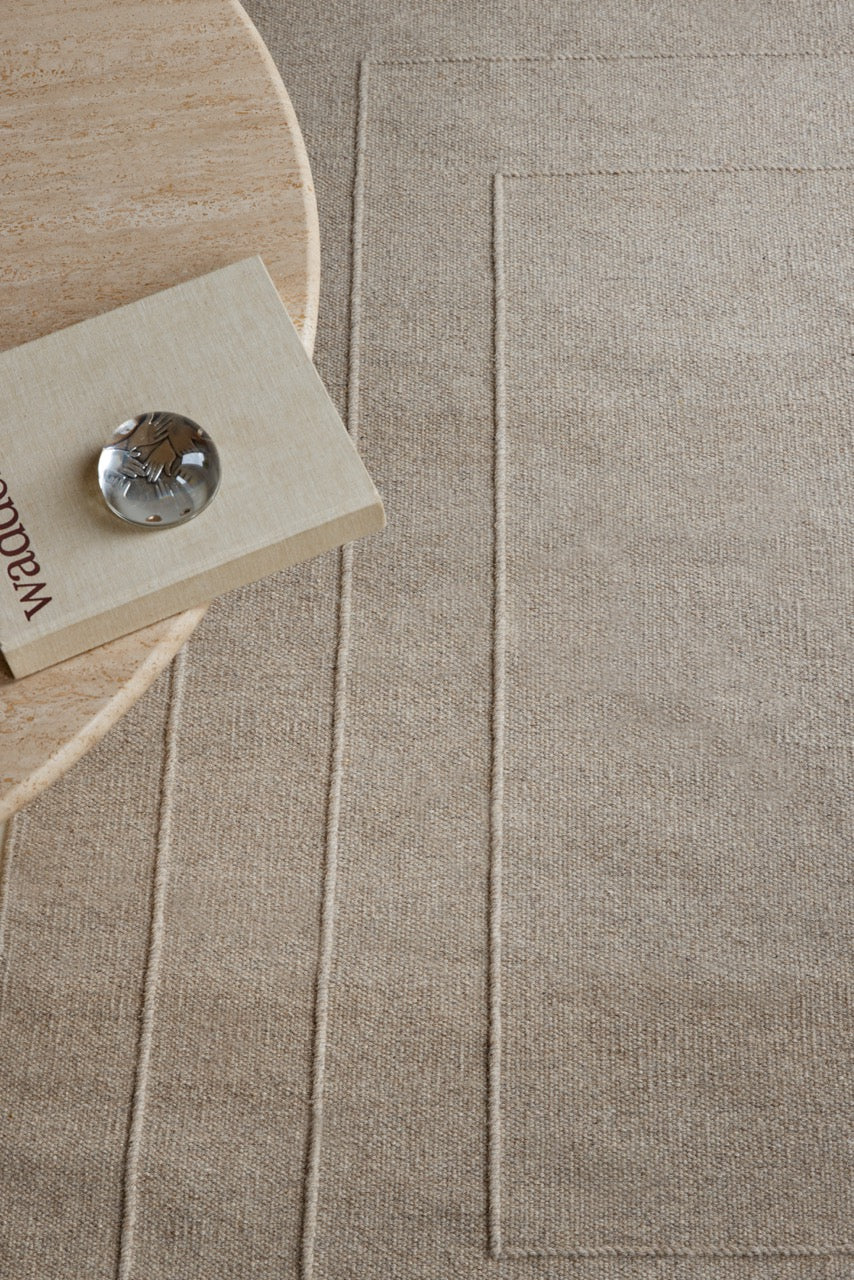 Brink & Campman Senso Border Soft Taupe rug in grey taupe with three frames in relief, shown in an interior, second view