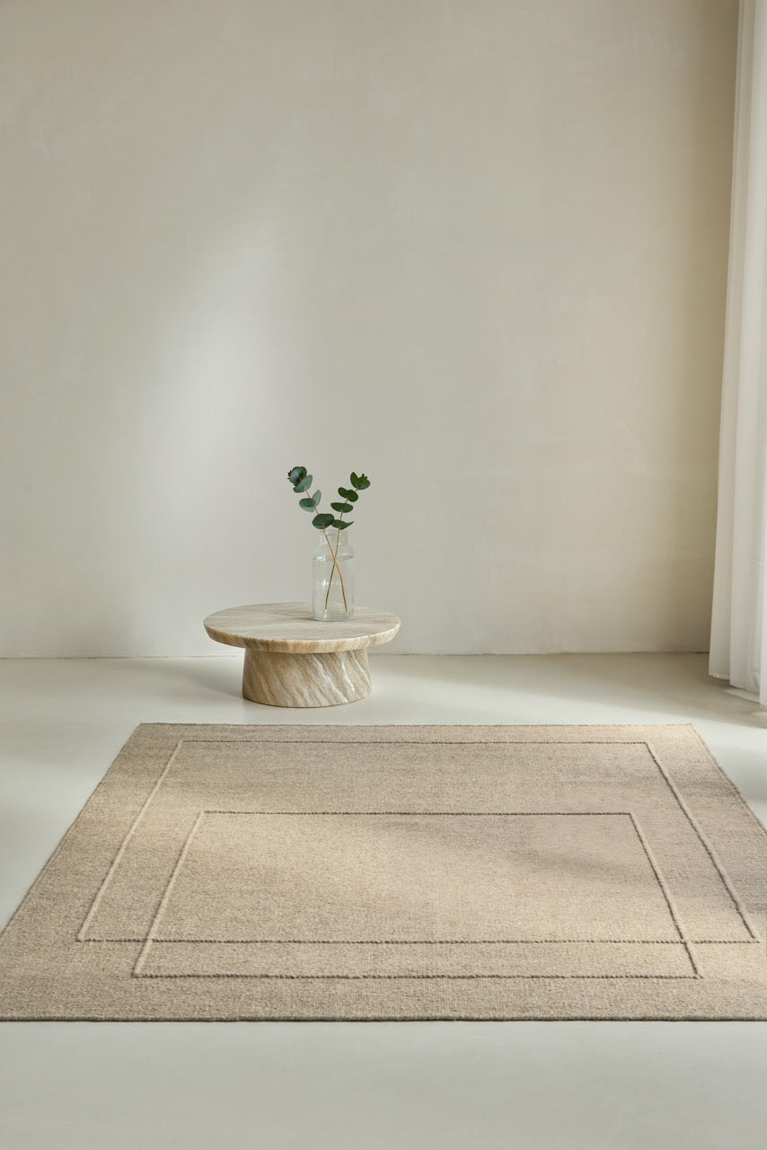 Brink & Campman Senso Level Natural rug in sand beige with two rectangles in relief, shown in an interior
