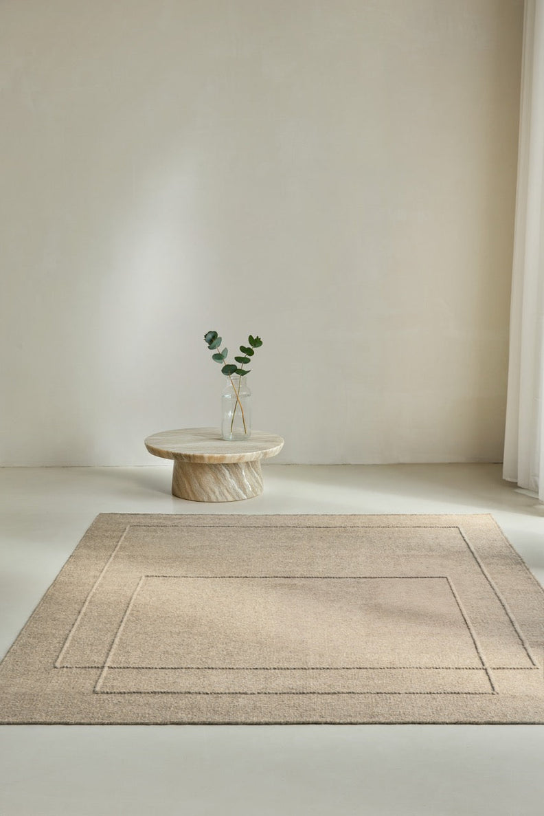 Brink & Campman Senso Level Natural rug in sand beige with two rectangles in relief, shown in an interior