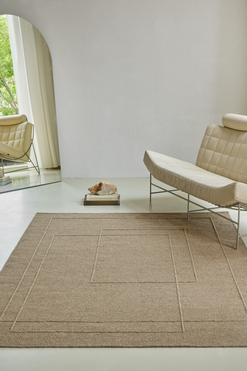 Brink & Campman Senso Planes Fur Brown rug in camel brown with overlapping rectangles in relief, shown in an interior