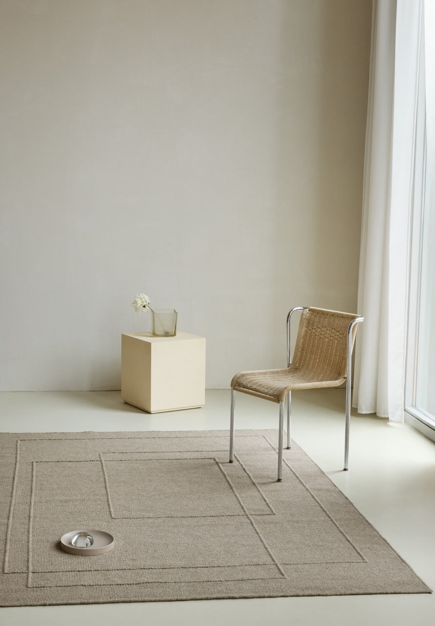 Brink & Campman Senso Planes Soft Taupe rug in grey taupe with overlapping rectangles in relief, shown in an interior
