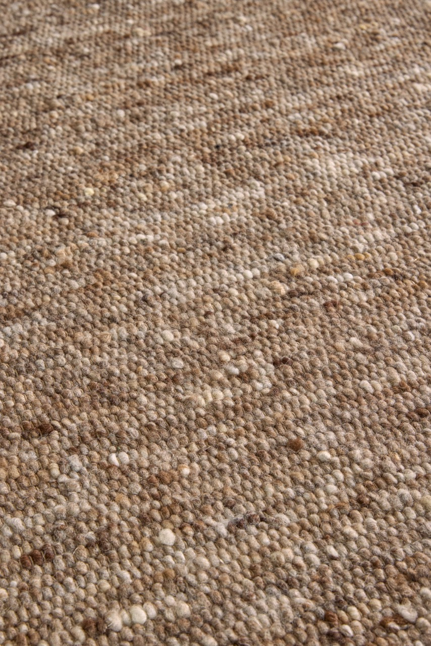 Brink & Campman Sober Soft Brown rug in mottled soft brown and taupe, shown in an interior, third view