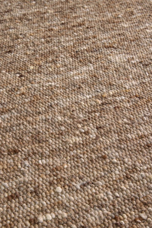 Brink & Campman Sober Soft Brown rug in mottled soft brown and taupe, shown in an interior, third view