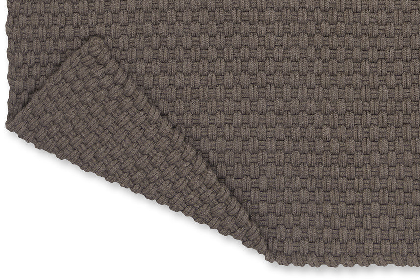 Close-up of recycled PET flatweave texture in soft grey and taupe tones

