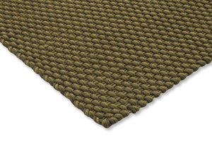 Corner view of Lace Thyme Pine rug showing braided surface and stitched edge