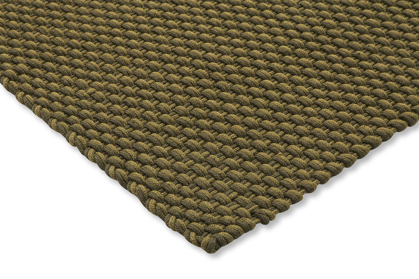 Corner view of Lace Thyme Pine rug showing braided surface and stitched edge