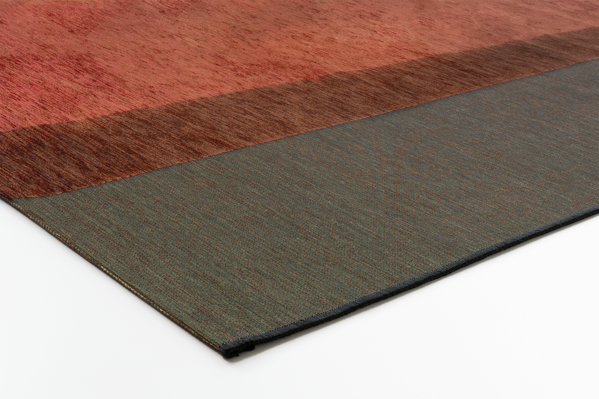 Corner of Acsento Capri Terra Forest rug showing edge detail and thin flatweave structure

