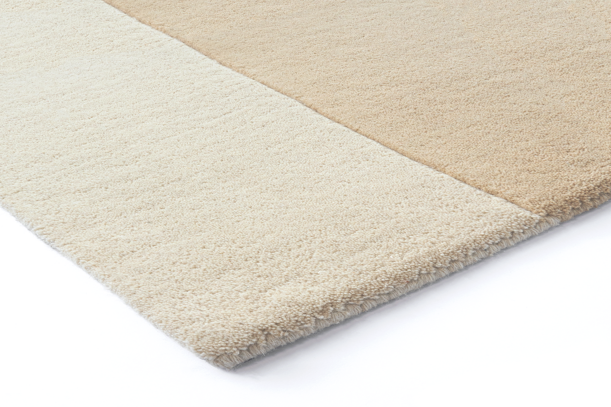 Corner of Acsento Lipari Beige rug showing soft wool edge and beige tonal layering

