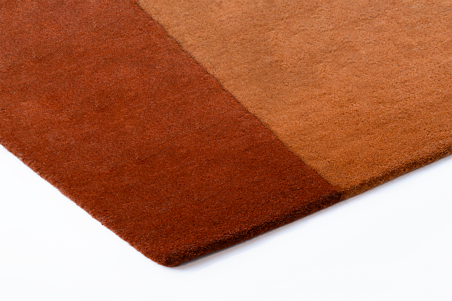 Corner of Acsento Lipari Terra rug showing handtufted detail and warm colour layering


