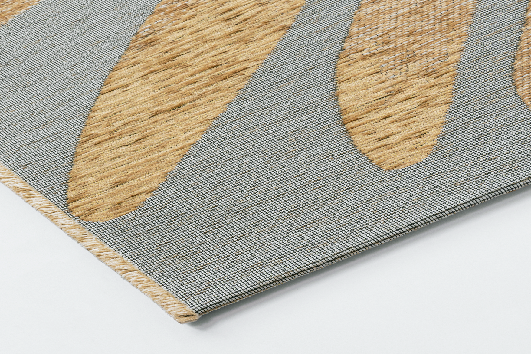 Corner detail of the Acsento Salerno Caramel rug showcasing its flatweave construction and clean edges.