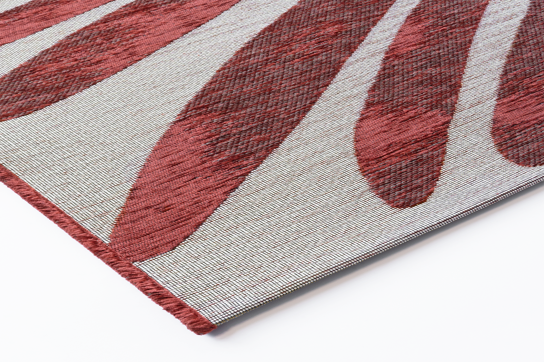 Corner detail of Acsento Salerno Rouge Castille rug showing tight flatwoven edge and striped detailing

