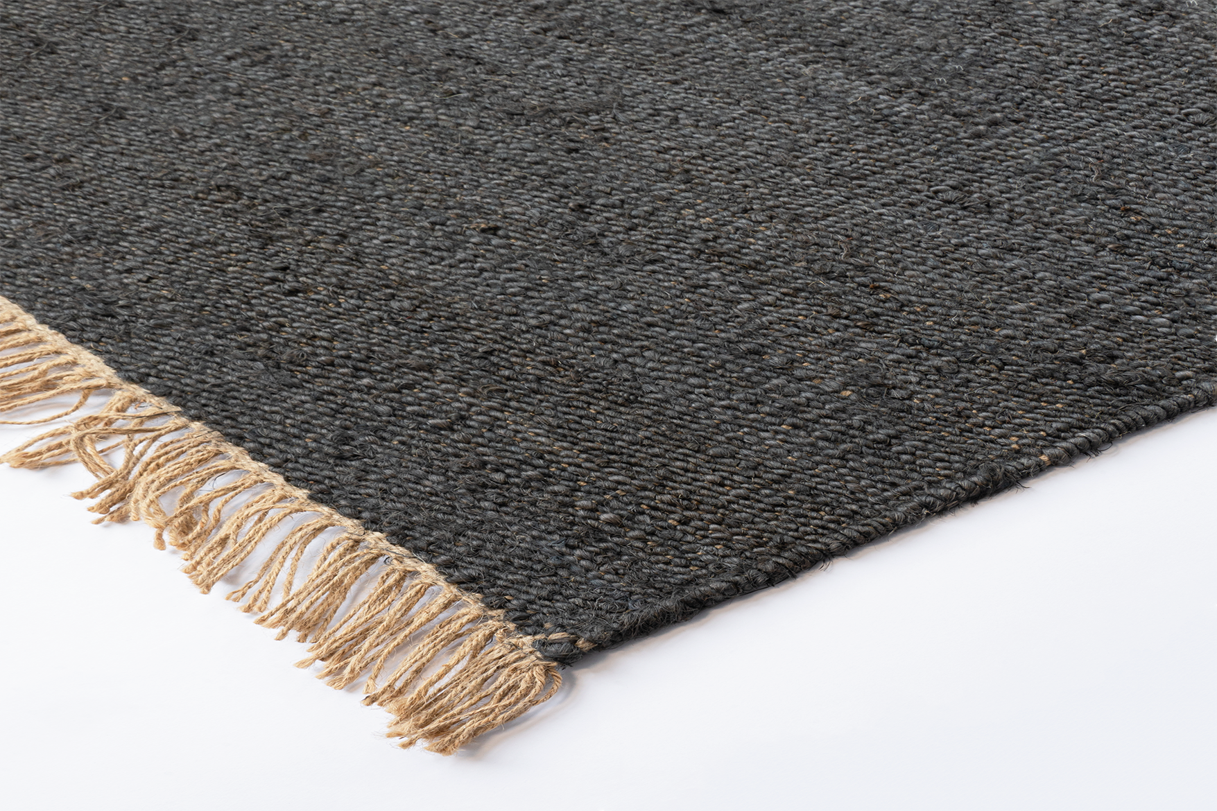 Corner of Acsento Vigo Charcoal jute rug with clean edges and low-profile flatweave finish

