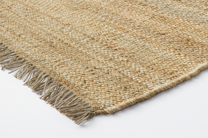 Corner detail of Acsento Vigo Natural rug with clean edge and slim flatweave construction


