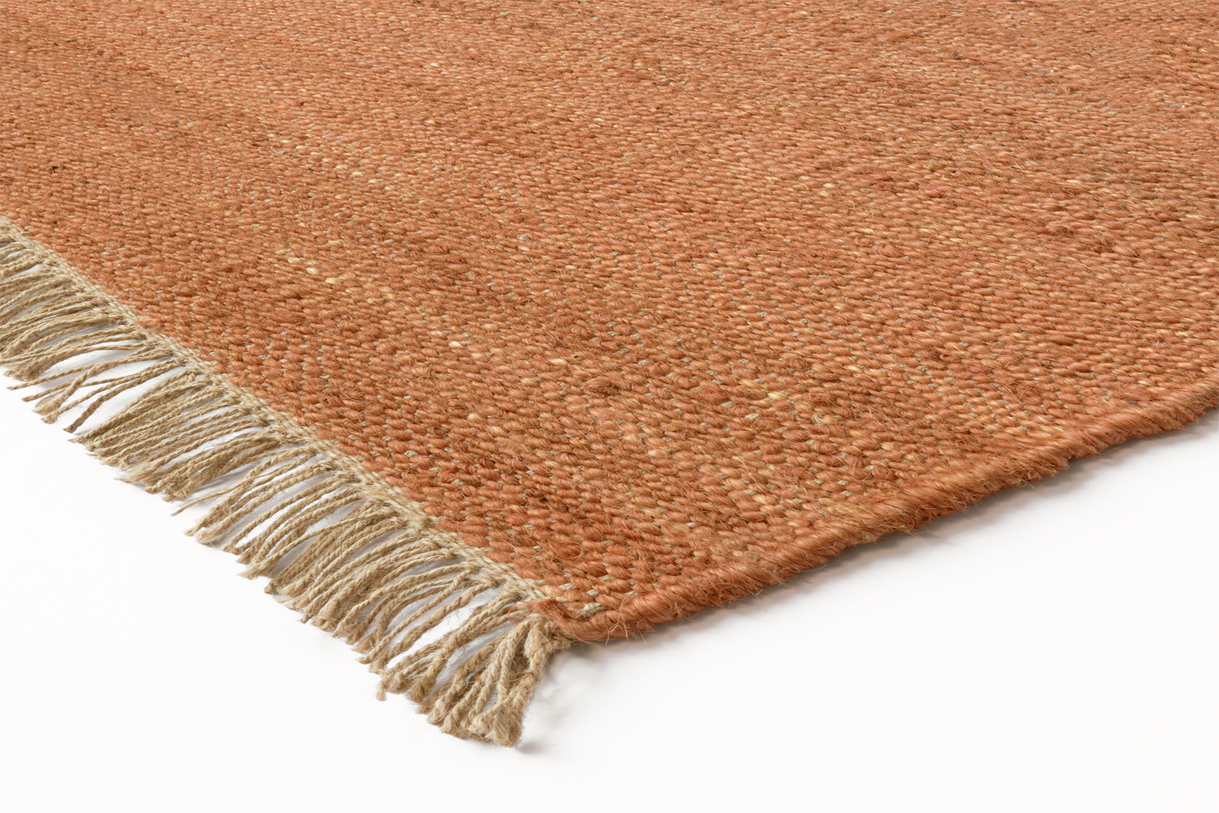 Corner detail of the Acsento Vigo Terracotta rug showcasing its flatweave construction and clean edges.

