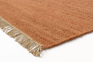 Corner detail of the Acsento Vigo Terracotta rug showcasing its flatweave construction and clean edges.


