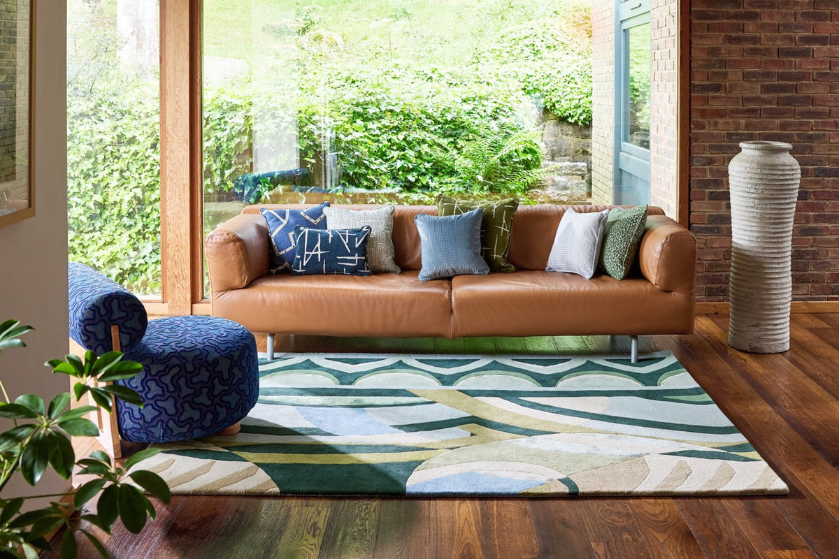 Harlequin Atelier Lagoon rug in bottle green, sea green and sky blue, shown in an interior