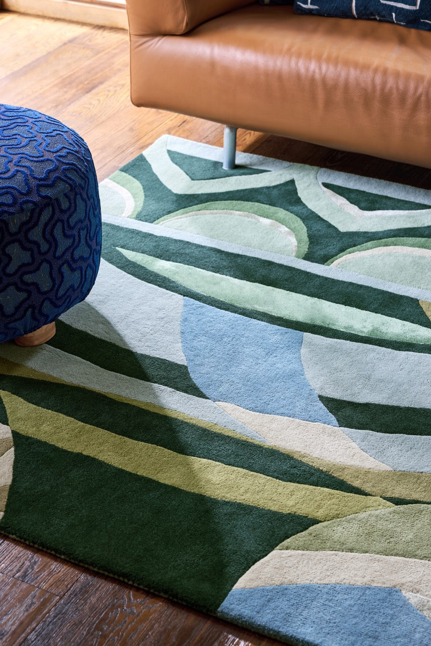 Harlequin Atelier Lagoon rug in bottle green, sea green and sky blue, shown in an interior, second view