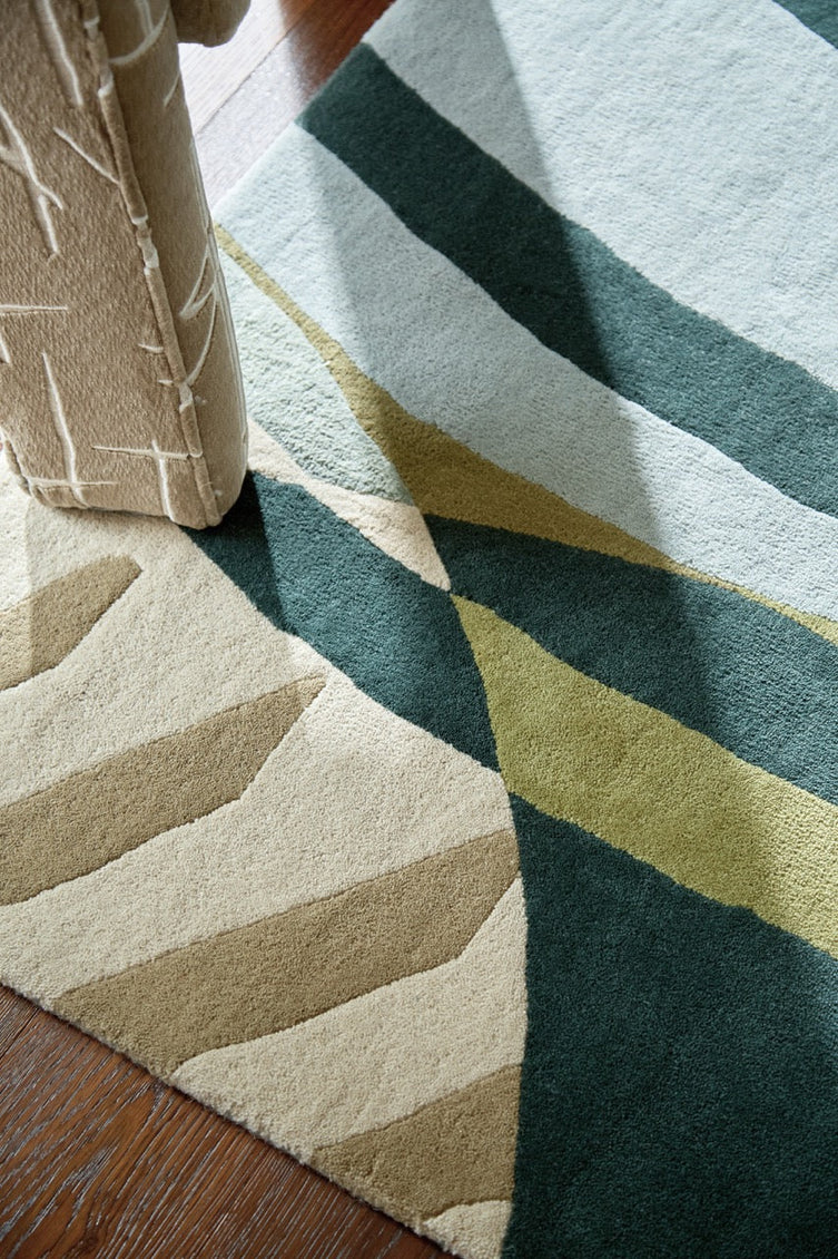 Harlequin Atelier Lagoon rug in bottle green, sea green and sky blue, shown in an interior, third view