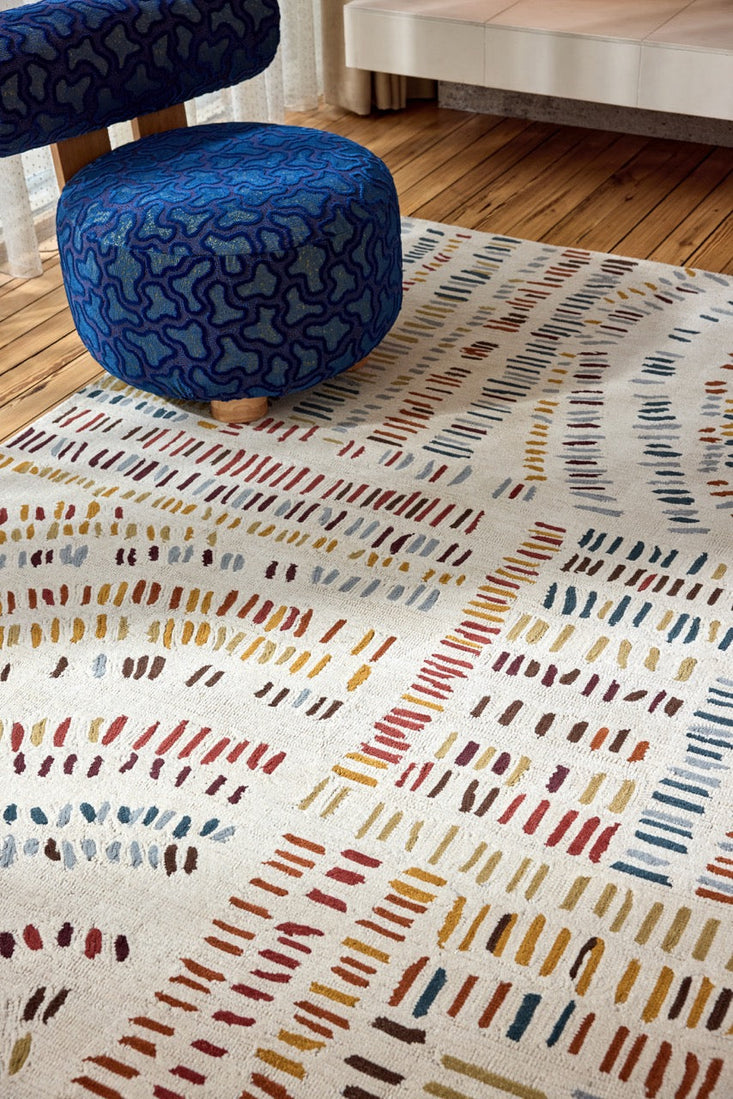 Harlequin Frescoes Amber rug in ivory with dashes in amber, rust and teal, shown in an interior, second view