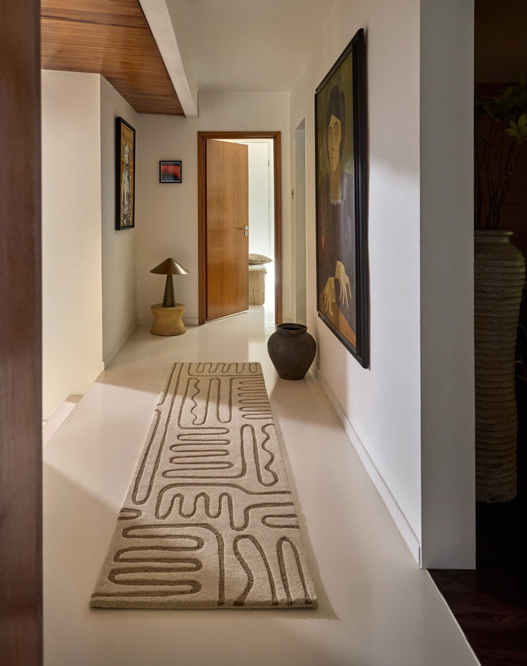 Harlequin Hollow Pebble runner in ivory with greige lines, shown in an interior