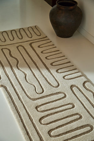 Harlequin Hollow Pebble runner in ivory with greige lines, shown in an interior, second view