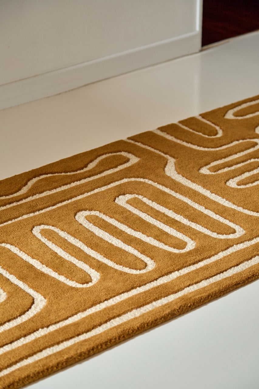 Harlequin Hollow Tan runner in caramel with ivory lines, shown in an interior, second view