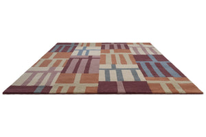 Harlequin Monolith Cinnabar Amber rug in burnt orange, wine red and denim blue, perspective view