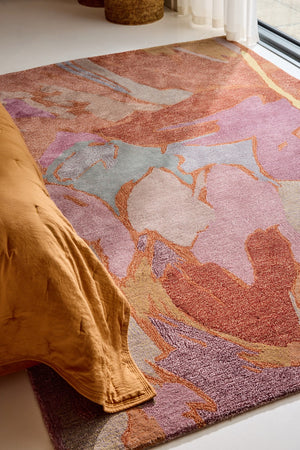 Harlequin Saltillo Rosewood rug in terracotta, rust and lilac, shown in an interior, second view
