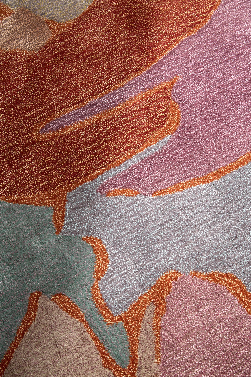 Harlequin Saltillo Rosewood rug in terracotta, rust and lilac, shown in an interior, third view