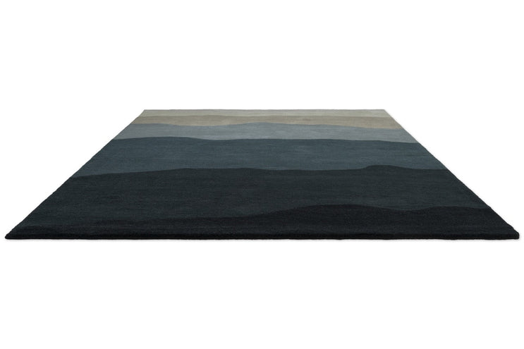 Harlequin Sedimentary Midnight rug in petrol blue and midnight blue, perspective view