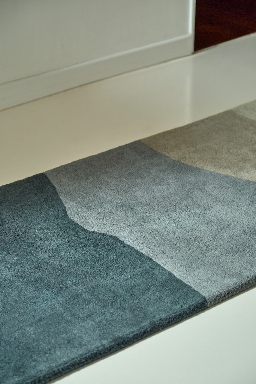 Harlequin Sedimentary Midnight runner in petrol blue and midnight blue, shown in an interior, second view