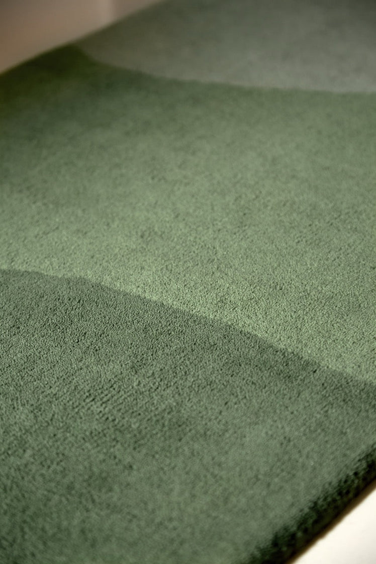 Harlequin Sedimentary Pine runner in pine green and sage, shown in an interior, third view
