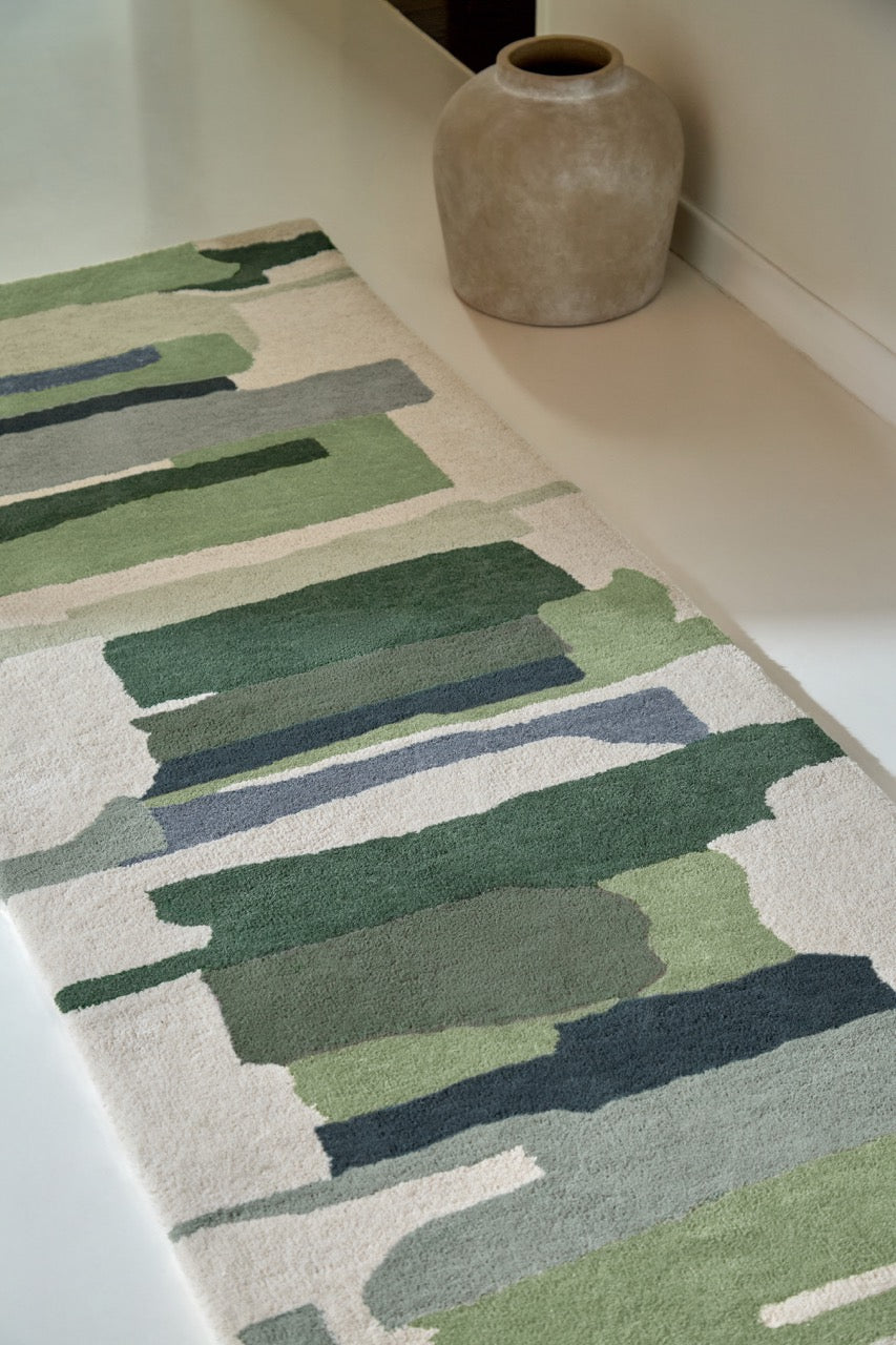Harlequin Zeal Forest runner in ivory with green brushstrokes, shown in an interior, second view