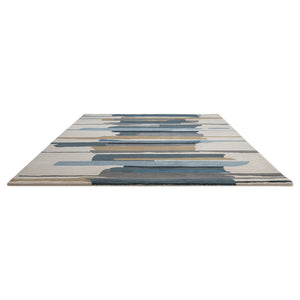 Harlequin Zeal Indigo rug in ivory with blue and ochre brushstrokes, perspective view