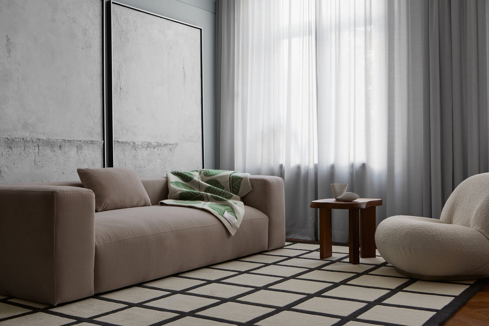 Layered Avenue Checked Bone White rug styled in a modern living room with neutral furnishings and natural accents.

