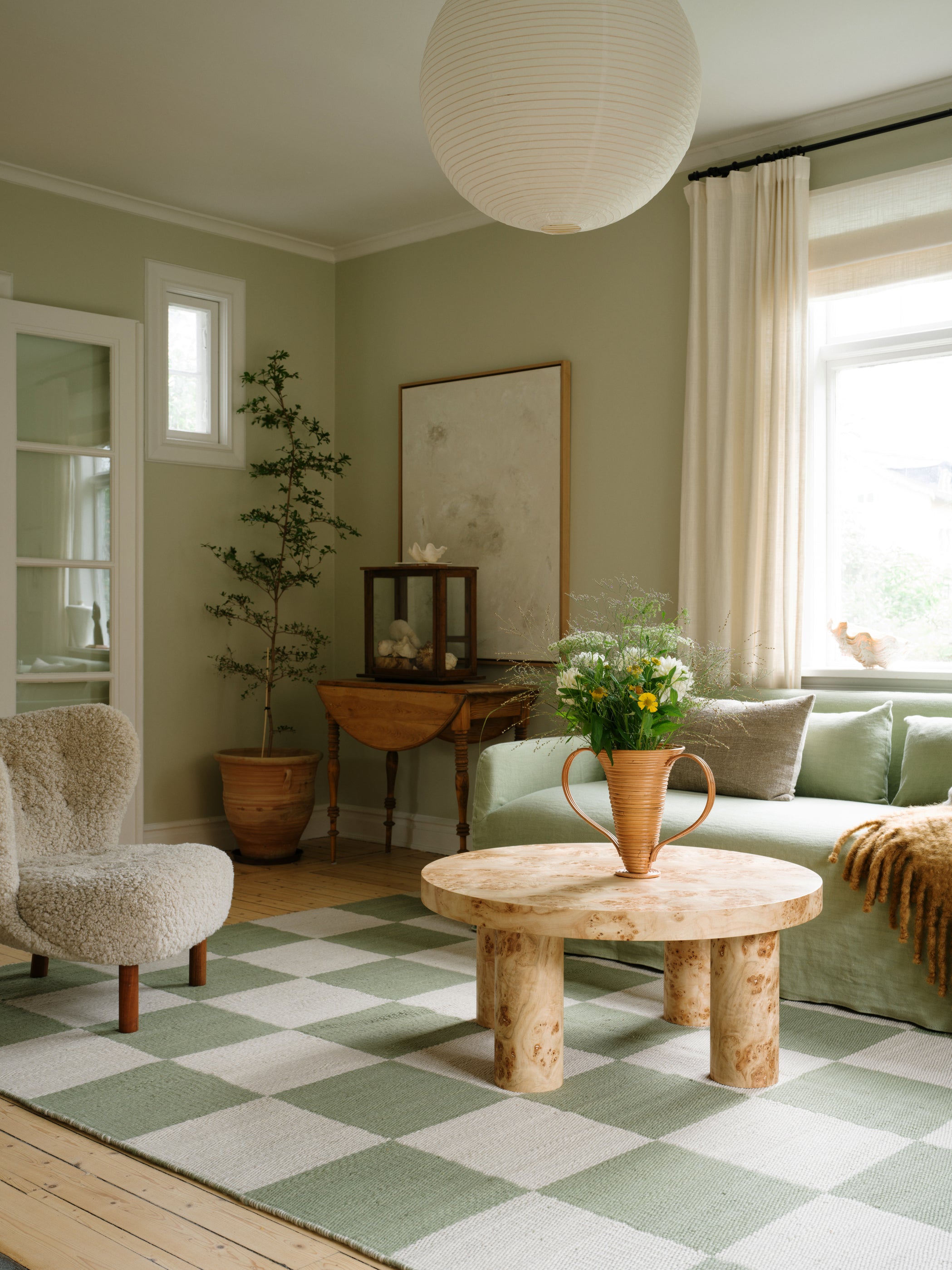 Layered Chess Sage rug styled in a minimal living space with oak accents and linen seating

