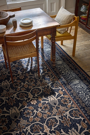 Morris & Co Borage Blue rug in indigo, ivory and caramel, shown in an interior, second view