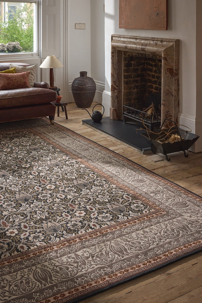 Morris & Co Borage Grey rug in stone grey, ivory and ochre, shown in an interior, second view