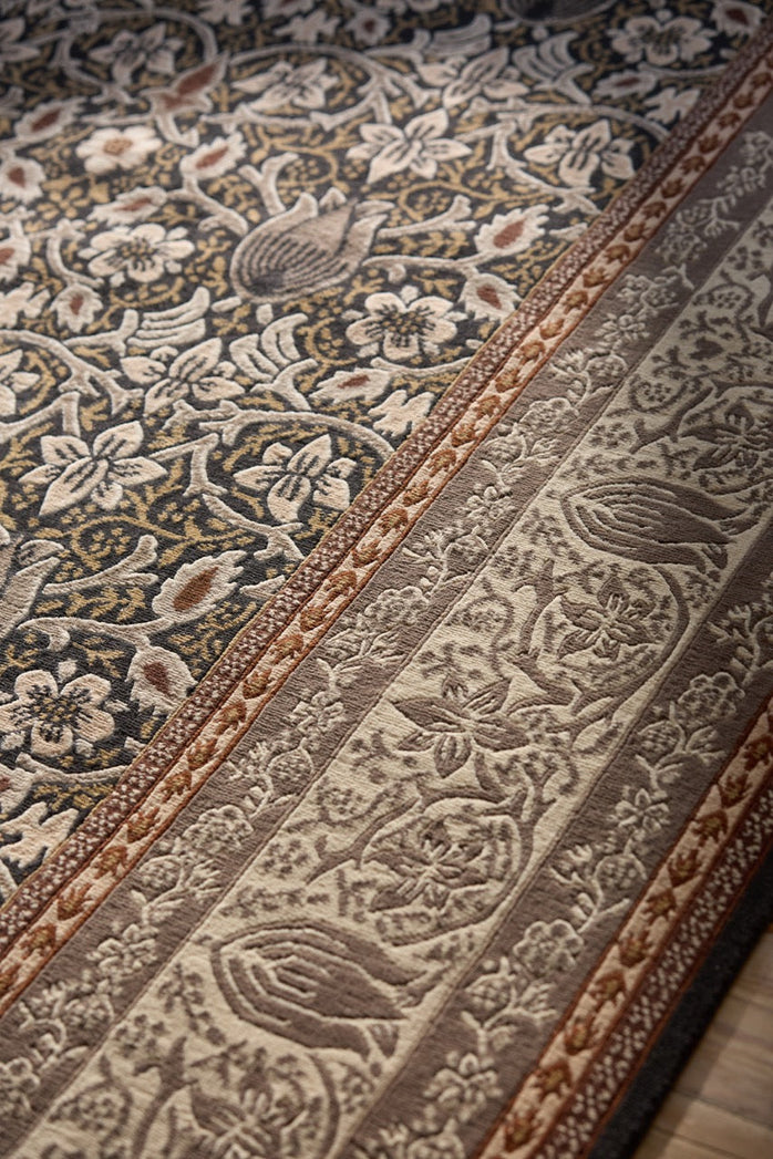 Morris & Co Borage Grey rug in stone grey, ivory and ochre, shown in an interior, third view