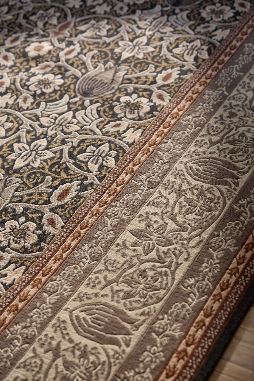 Morris & Co Borage Grey rug in stone grey, ivory and ochre, shown in an interior, third view