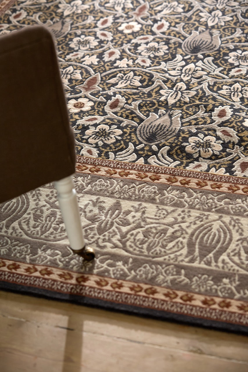 Morris & Co Borage Grey rug in stone grey, ivory and ochre, shown in an interior, fourth view