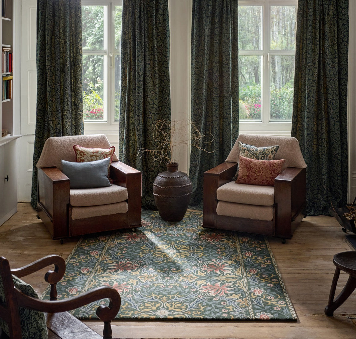 Morris & Co Walthamstow Forest Teal rug in forest green, teal and old gold, shown in an interior
