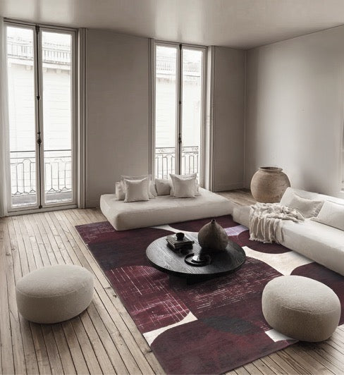 Acsento Bubbles Burgundy rug in burgundy with rounded shapes in wine red and aubergine on ivory, shown in an interior
