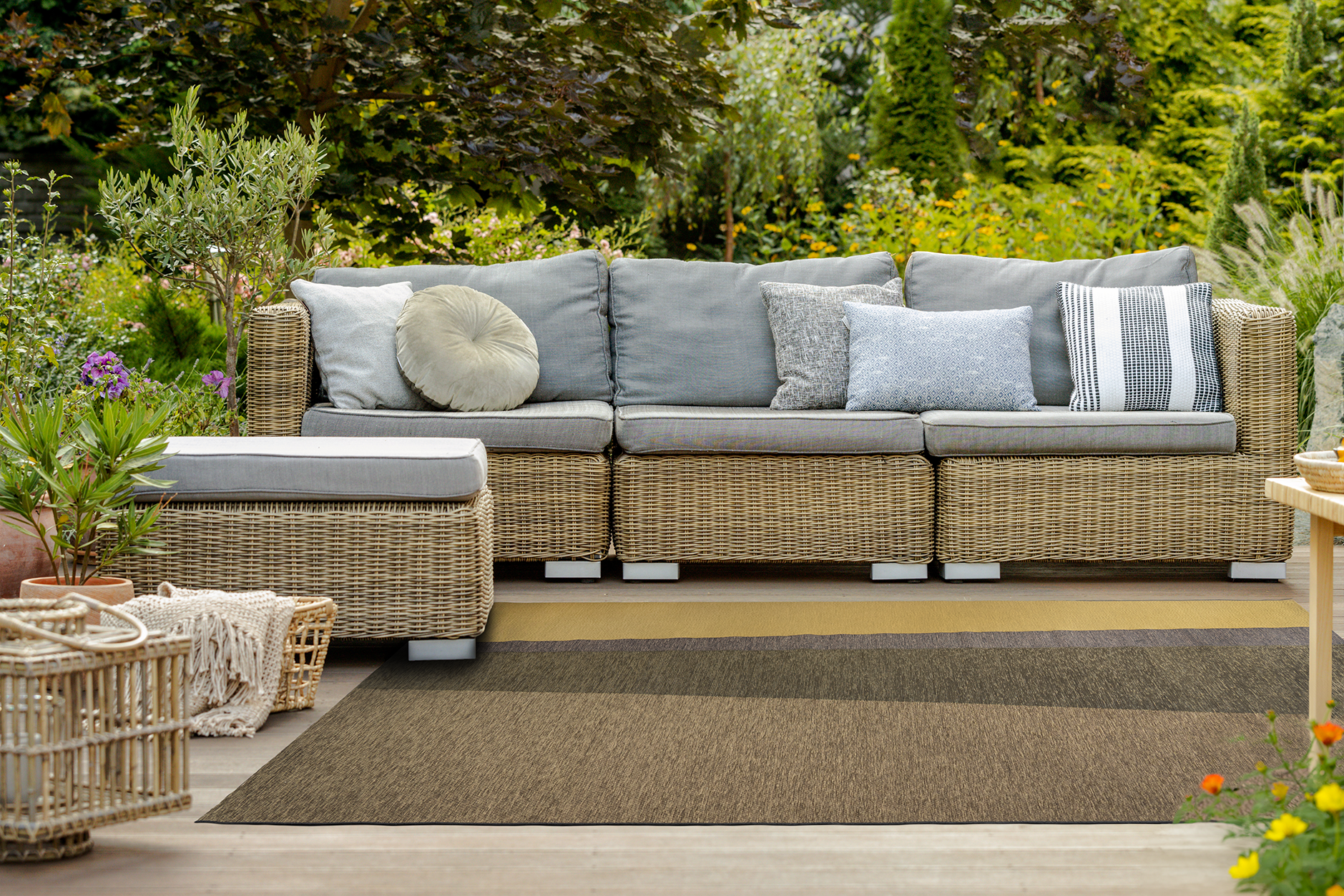 Acsento Capri Gold Olive rug styled in a outdoor lounge with wood and olive green accents

