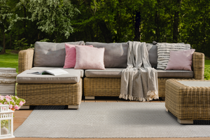 Acsento Chania Ivory PET rug styled in a bright, coastal-inspired living room with pale wood accents

