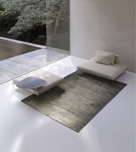 Acsento Moonshadow Green rug in grey green with fine horizontal lines, shown in an interior