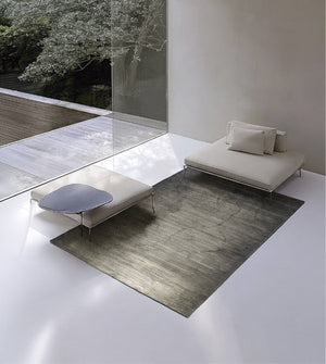 Acsento Moonshadow Green rug in grey green with fine horizontal lines, shown in an interior